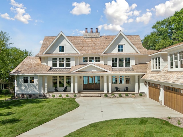 2475 Dunwoody Ave, Orono, MN 55391 - view of front facade featuring concrete driveway, covered porch, a chimney, a garage, and a front yard