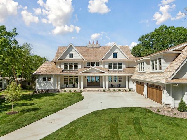 2475 Dunwoody Ave, Orono, MN 55391 - shingle-style home featuring an attached garage, driveway, a chimney, a porch, and a front yard