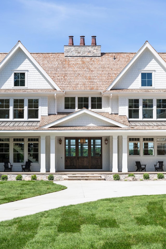 2475 Dunwoody Ave, Orono, MN 55391 - shingle-style home with a chimney, a front yard, and a porch