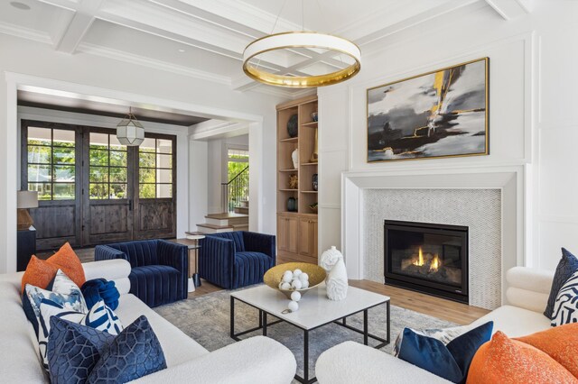 2475 Dunwoody Ave, Orono, MN 55391 - living area featuring wood finished floors, coffered ceiling, ornamental molding, a glass covered fireplace, and beam ceiling