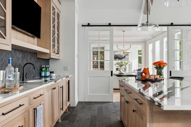 2475 Dunwoody Ave, Orono, MN 55391 - kitchen with backsplash, a barn door, a sink, and glass insert cabinets