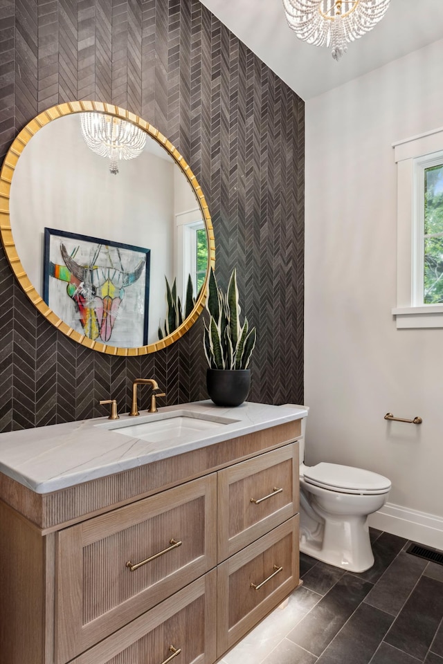 2475 Dunwoody Ave, Orono, MN 55391 - bathroom featuring a chandelier, baseboards, vanity, toilet, and wallpapered walls