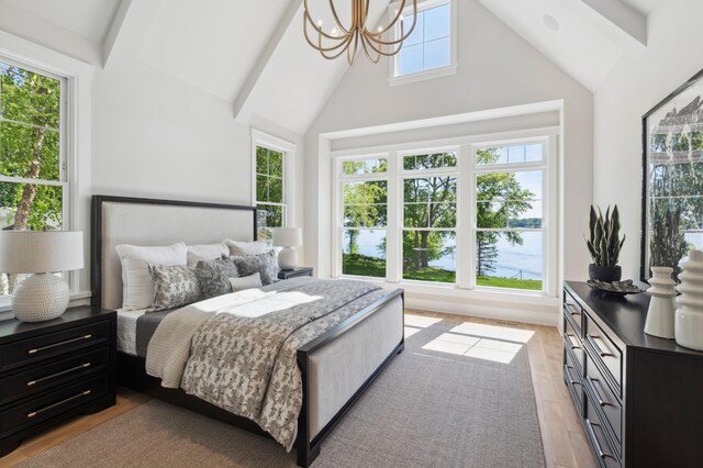 2475 Dunwoody Ave, Orono, MN 55391 - bedroom featuring a chandelier, light wood-type flooring, beamed ceiling, high vaulted ceiling, and a water view