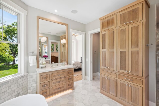 2475 Dunwoody Ave, Orono, MN 55391 - full bath featuring ensuite bathroom, a soaking tub, vanity, and tile patterned flooring