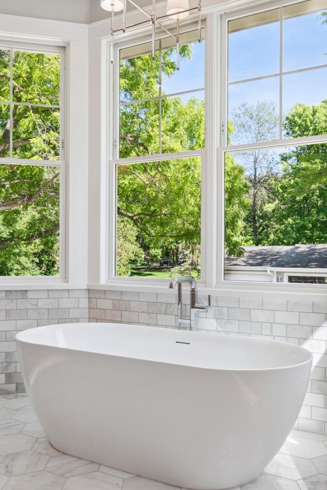 2475 Dunwoody Ave, Orono, MN 55391 - bathroom featuring a sink, a freestanding tub, and marble finish flooring