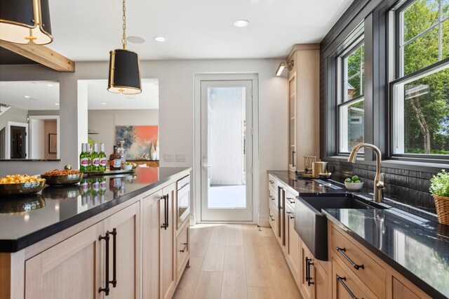 2475 Dunwoody Ave, Orono, MN 55391 - kitchen with a sink, light wood finished floors, recessed lighting, light brown cabinetry, and decorative light fixtures