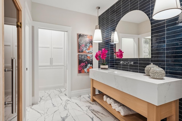 2475 Dunwoody Ave, Orono, MN 55391 - bathroom with marble finish floors, vanity, tile walls, and baseboards