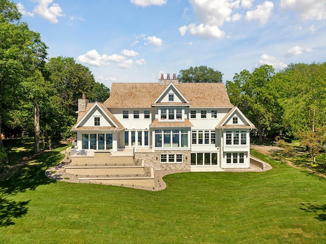 2475 Dunwoody Ave, Orono, MN 55391 - back of property featuring a chimney, a lawn, and a patio