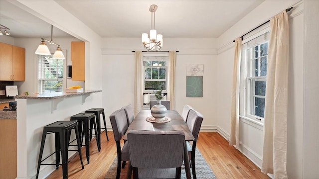 3400 List Pl Unit 1, Minneapolis, MN 55416 - dining room with healthy amount of natural light, light wood-type flooring, and a chandelier