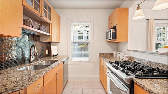 3400 List Pl Unit 1, Minneapolis, MN 55416 - kitchen with appliances with stainless steel finishes, a sink, baseboards, backsplash, and light tile patterned flooring