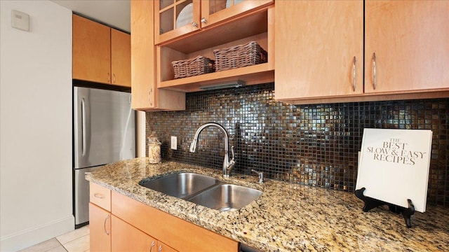 3400 List Pl Unit 1, Minneapolis, MN 55416 - kitchen with a sink, freestanding refrigerator, tasteful backsplash, light stone countertops, and light brown cabinetry