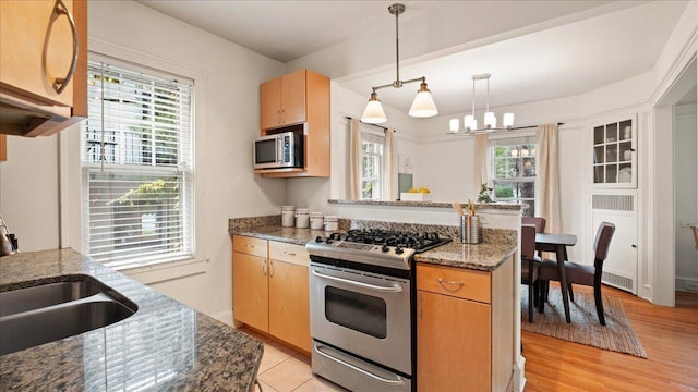 3400 List Pl Unit 1, Minneapolis, MN 55416 - kitchen featuring appliances with stainless steel finishes, a chandelier, a sink, and healthy amount of natural light