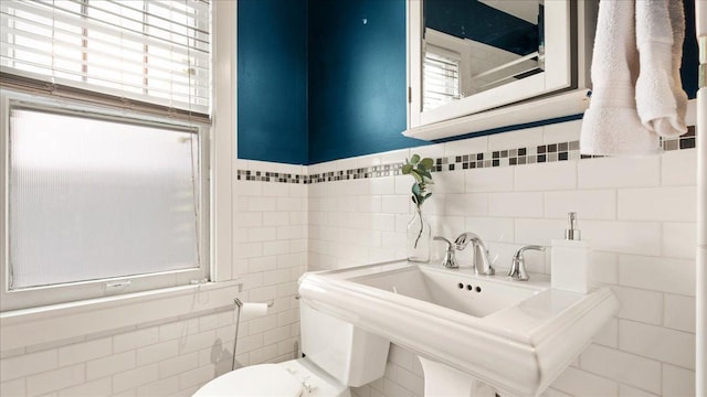 3400 List Pl Unit 1, Minneapolis, MN 55416 - half bathroom featuring tile walls, healthy amount of natural light, toilet, and a sink