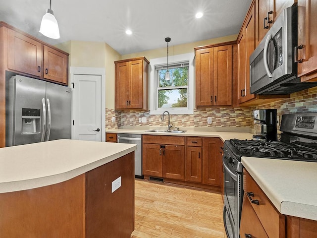 2727 3rd St, Minneapolis, MN 55411 - kitchen featuring appliances with stainless steel finishes, brown cabinetry, decorative backsplash, light wood-type flooring, and decorative light fixtures