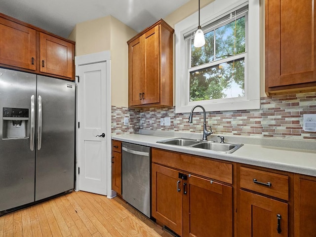 2727 3rd St, Minneapolis, MN 55411 - kitchen with appliances with stainless steel finishes, brown cabinets, and light countertops