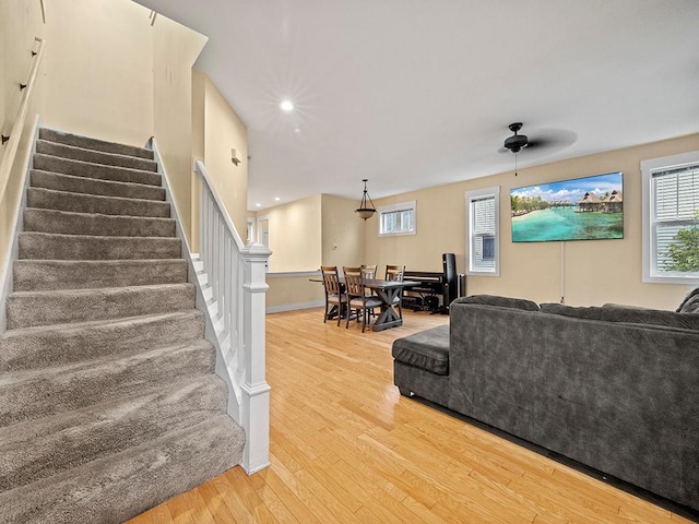 2727 3rd St, Minneapolis, MN 55411 - living room with light wood-style flooring, a ceiling fan, stairway, healthy amount of natural light, and recessed lighting