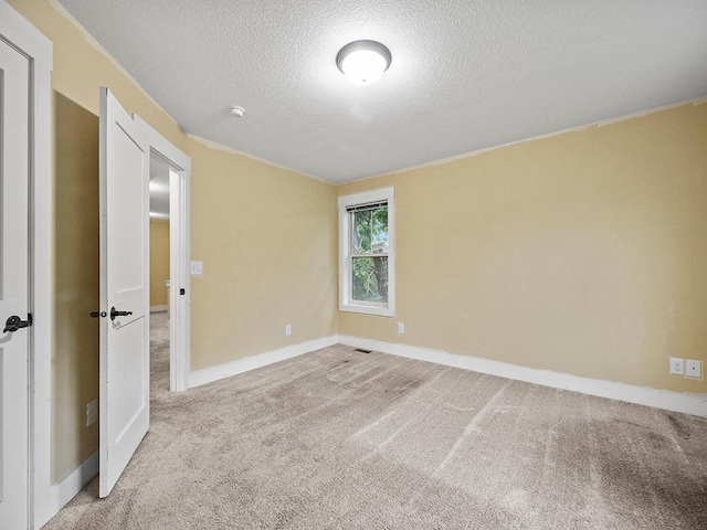 2727 3rd St, Minneapolis, MN 55411 - carpeted empty room featuring a textured ceiling and baseboards