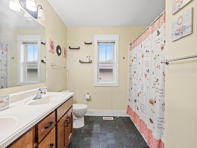 2727 3rd St, Minneapolis, MN 55411 - full bath featuring healthy amount of natural light, double vanity, stone finish floors, and a shower with curtain