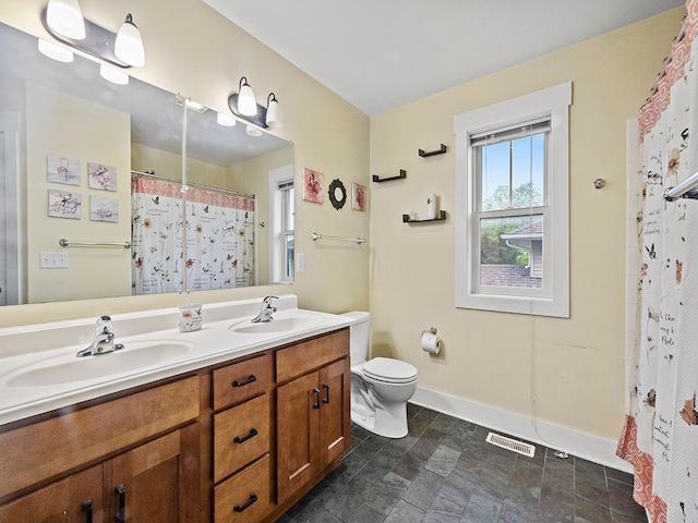 2727 3rd St, Minneapolis, MN 55411 - bathroom with double vanity, curtained shower, and stone finish flooring