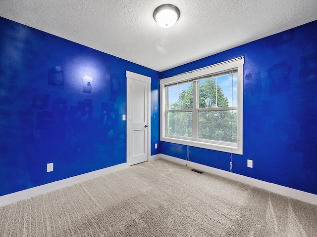 2727 3rd St, Minneapolis, MN 55411 - empty room with a textured ceiling and carpet
