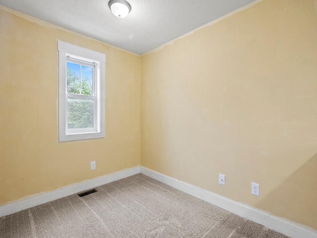 2727 3rd St, Minneapolis, MN 55411 - carpeted spare room featuring a textured ceiling and crown molding