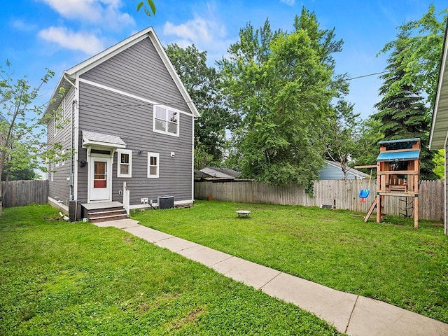 2727 3rd St, Minneapolis, MN 55411 - back of house with a playground and a fenced backyard