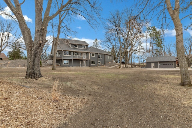 10267 Ferry Point Pl NW, Watab Twp, MN 56367 - rear view of property featuring a garage, a wooden deck, and an outbuilding