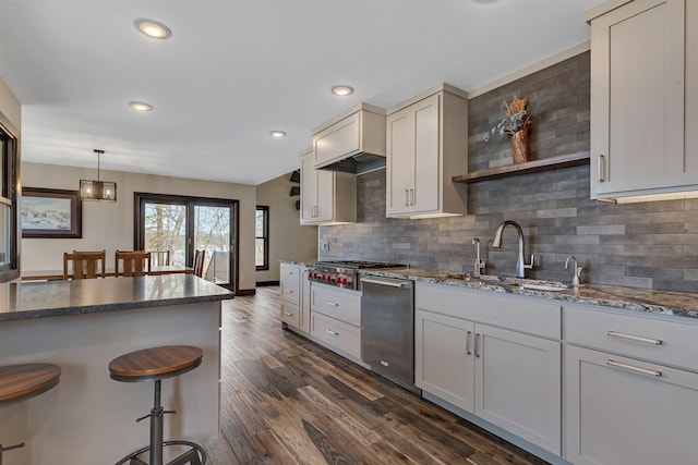 10267 Ferry Point Pl NW, Watab Twp, MN 56367 - kitchen with appliances with stainless steel finishes, a sink, a kitchen breakfast bar, decorative backsplash, and dark stone counters