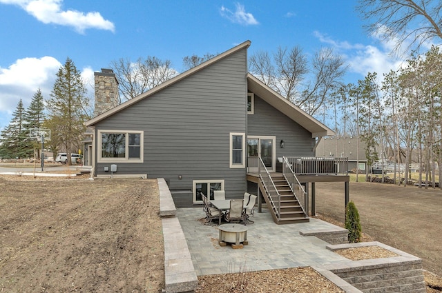 10267 Ferry Point Pl NW, Watab Twp, MN 56367 - rear view of house with a deck, stairs, a patio area, and a chimney