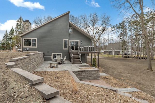 10267 Ferry Point Pl NW, Watab Twp, MN 56367 - back of property featuring a patio, a deck, stairs, and a chimney