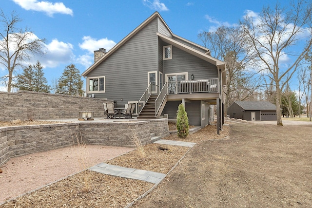 10267 Ferry Point Pl NW, Watab Twp, MN 56367 - rear view of house with a deck, stairs, a chimney, a detached garage, and a patio