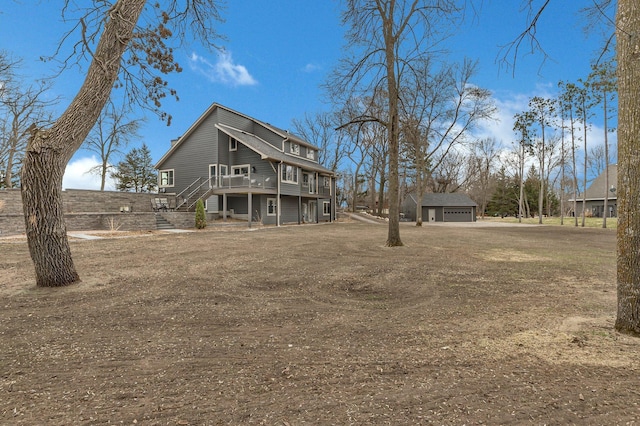 10267 Ferry Point Pl NW, Watab Twp, MN 56367 - rear view of house featuring stairs, a detached garage, and a wooden deck