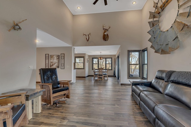 10267 Ferry Point Pl NW, Watab Twp, MN 56367 - living room with dark wood-type flooring, ceiling fan, a towering ceiling, a chandelier, and baseboards