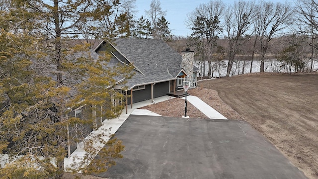 10267 Ferry Point Pl NW, Watab Twp, MN 56367 - view of property exterior with a chimney and driveway