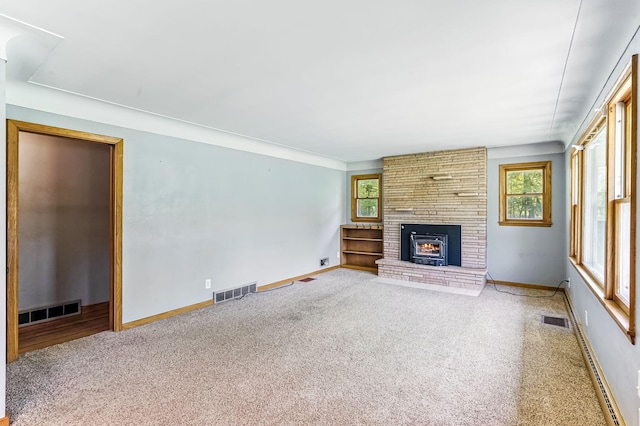 20257 Viking Blvd NE, Wyoming, MN 55092 - unfurnished living room with a brick fireplace, healthy amount of natural light, carpet, and baseboards