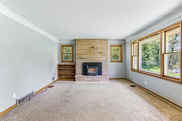 20257 Viking Blvd NE, Wyoming, MN 55092 - unfurnished living room featuring plenty of natural light, a fireplace, carpet, and baseboards