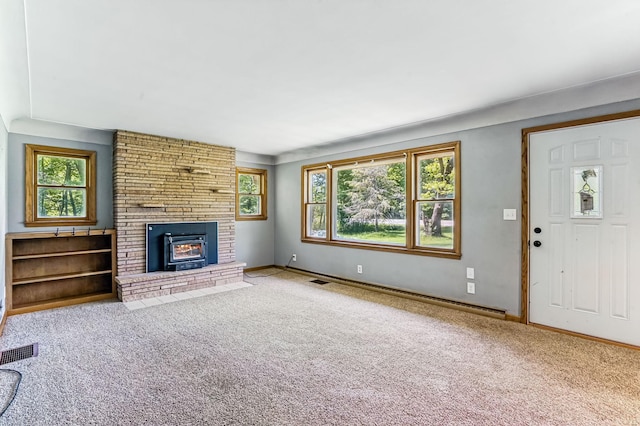 20257 Viking Blvd NE, Wyoming, MN 55092 - unfurnished living room featuring carpet floors, a baseboard radiator, a brick fireplace, and baseboards