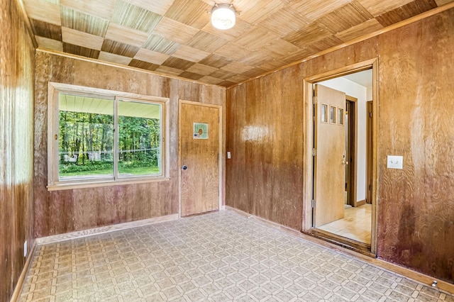 20257 Viking Blvd NE, Wyoming, MN 55092 - unfurnished room featuring wooden walls, tile patterned floors, and baseboards