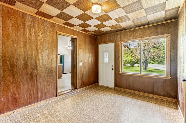 20257 Viking Blvd NE, Wyoming, MN 55092 - empty room featuring light floors, wooden walls, wooden ceiling, and baseboards