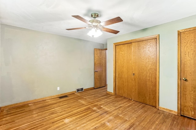 20257 Viking Blvd NE, Wyoming, MN 55092 - unfurnished bedroom with wood-type flooring, ceiling fan, baseboards, and a closet