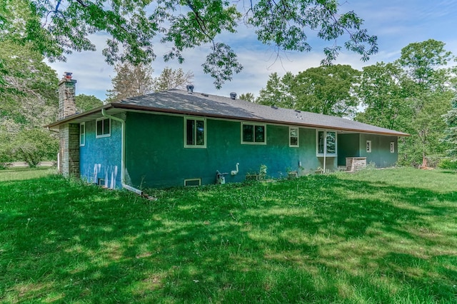 20257 Viking Blvd NE, Wyoming, MN 55092 - back of property featuring a chimney, stucco siding, and a yard