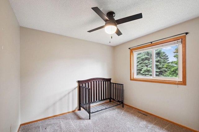 11813 Kerry St NW, Coon Rapids, MN 55433 - carpeted bedroom with a crib, a textured ceiling, and ceiling fan