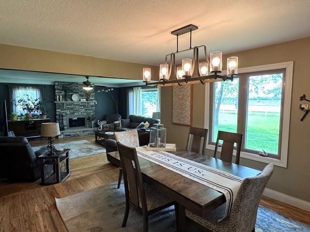 208 Mason Ave, Verndale, MN 56481 - dining room with a chandelier, ceiling fan, wood finished floors, baseboards, and a textured ceiling