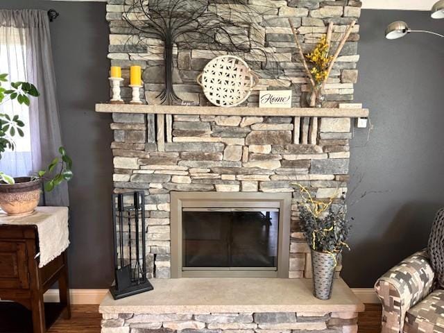 208 Mason Ave, Verndale, MN 56481 - detailed view of a fireplace, wood finished floors, and baseboards