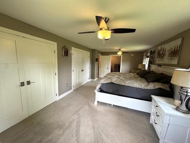 208 Mason Ave, Verndale, MN 56481 - bedroom featuring light colored carpet, ceiling fan, baseboards, and multiple closets