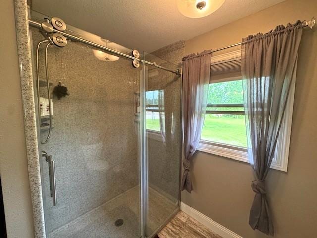 208 Mason Ave, Verndale, MN 56481 - bathroom featuring a stall shower and baseboards