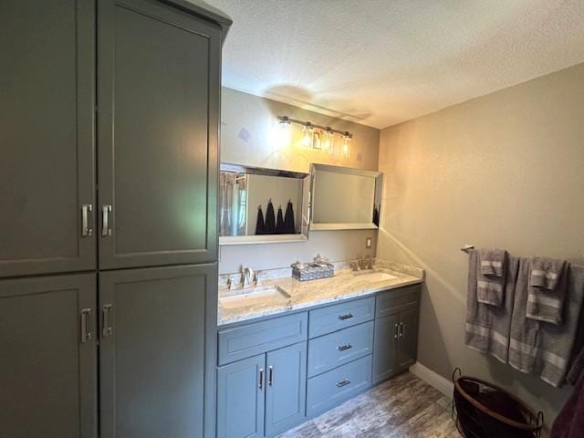 208 Mason Ave, Verndale, MN 56481 - full bath with double vanity, wood finished floors, a textured ceiling, and baseboards