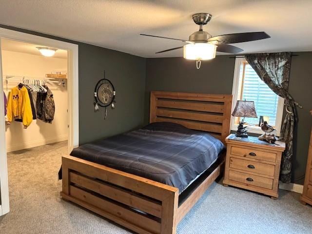 208 Mason Ave, Verndale, MN 56481 - bedroom featuring a walk in closet, carpet flooring, baseboards, and ceiling fan