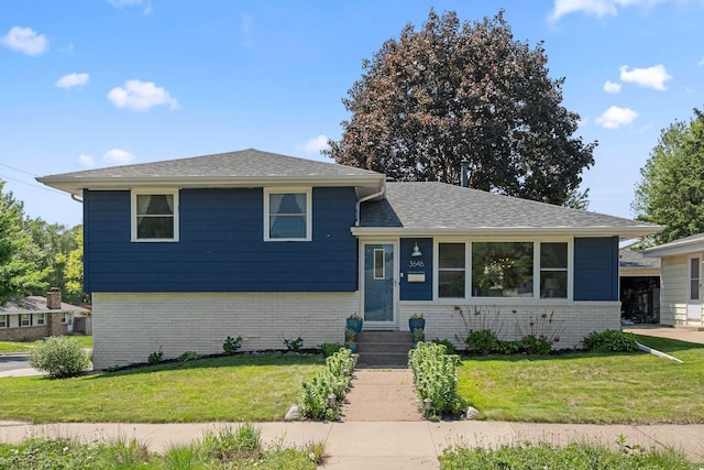 3646 Buchanan St NE, Minneapolis, MN 55418 - tri-level home featuring brick siding, a front yard, entry steps, and roof with shingles