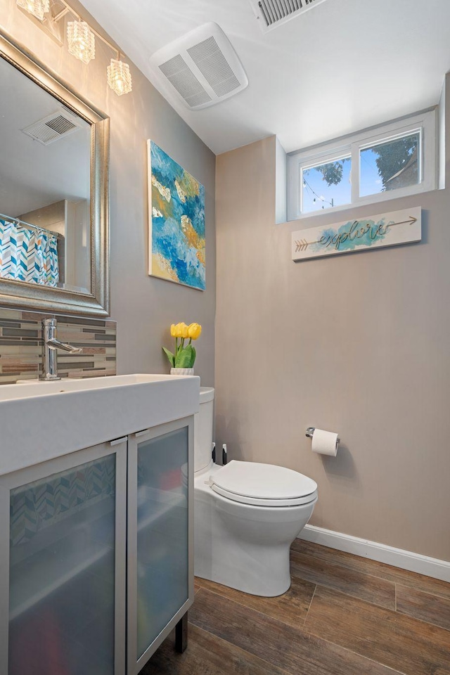 3646 Buchanan St NE, Minneapolis, MN 55418 - bathroom featuring toilet, wood finished floors, vanity, and baseboards